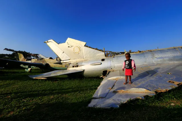 A child plays on the wreckages of war planes destroyed during an Israeli operation on the Entebbe international airport in 1976 to rescue hostages, at Aero beach, south of Uganda's capital Kampala, July 3, 2016. (Photo by James Akena/Reuters)