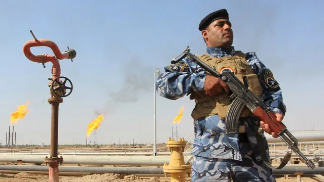 A member of the oil police force stands guard at Nahr Bin Umar oil field, north of Basra, southeast of Baghdad August 19, 2015. Iraq's oil exports have fallen by at least 250,000 barrels per day (bpd) so far in August according to loading data, making it less likely the several-month trend of rising OPEC output that has weakened oil prices will be sustained this month. (Photo by Essam Al-Sudani/Reuters)