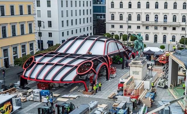 A model of a giant Porsche stands on Wittelsbacherplatz in the city centre in Munich, Germany on August 31, 2023. The square will be used for the IAA Mobility exhibition in the Bavarian capital. (Photo by Martin Schulz/AP Photo)