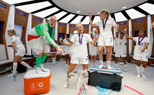 (L-R) Ellie Roebuck, Rachel Daly and Beth Mead of England celebrate in the changing room with the Women's EURO 2022 Trophy after the UEFA Women's Euro 2022 final match between England and Germany at Wembley Stadium on July 31, 2022 in London, England. (Photo by Lynne Cameron – The FA/The FA via Getty Images)