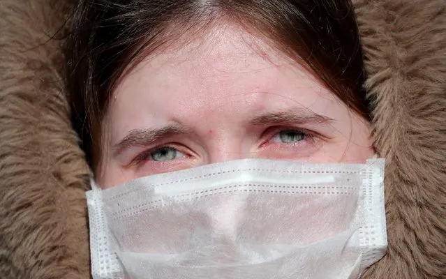 A woman wears a medical face mask near a hospital for infectious diseases in Minsk, Belarus, 28 February 2020. Belarusian authorities have reported the first confirmed case of the COVID-19 disease caused by the novel SARS-CoV-2 coronavirus (which was first discovered in the Chinese city of Wuhan) in the Eastern European country. (Photo by Tatyana Zenkovich/EPA/EFE/Rex Features/Shutterstock)