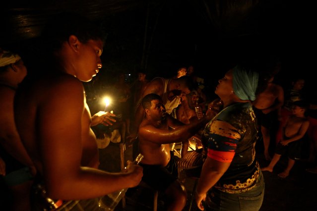 Followers of the goddess Maria Lionza participate in a spiritual ritual that combines Indigenous, Catholic and African beliefs, in Quibayo, Venezuela on October 11, 2024. (Photo by Juan Carlos Hernandez/Reuters)
