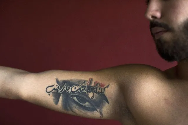 In this Tuesday, May 31, 2016 photo, Abbas, 23, poses for a photo showing off his tattoos of Shiite Muslim religious slogans with Arabic that reads “We are all your Abbas, oh Zeinab”, in the southern suburb of Beirut, Lebanon. (Photo by Hassan Ammar/AP Photo)