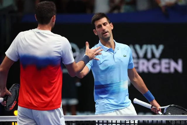 Serbia's Novak Djokovic (R) greets Croatia's Marin Cilic after their men's singles final tennis match at the Tel Aviv Watergen Open 2022 in Israel on October 1, 2022. Djokovic won 6-3 and 6-4. (Photo by Jack Guez/AFP Photo)
