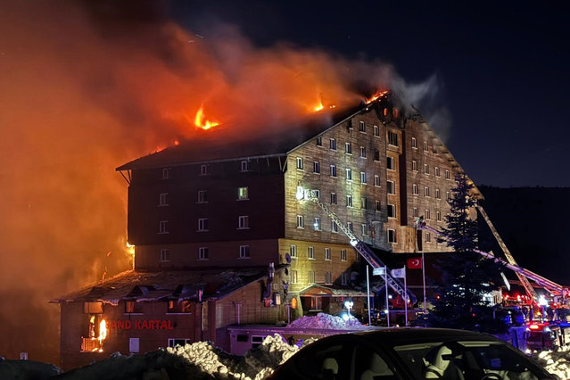 Firefighters work to extinguish a fire in a hotel at a ski resort of Kartalkaya in Bolu province, in northwest Turkey, Tuesday, January 21, 2025. (Photo by IHA via AP Photo)