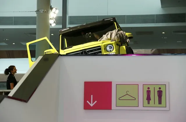 A woman looks at the new Mercedes-Benz G500 4x4 car during the media day at the Frankfurt Motor Show (IAA) in Frankfurt, Germany, September 14, 2015. (Photo by Ralph Orlowski/Reuters)