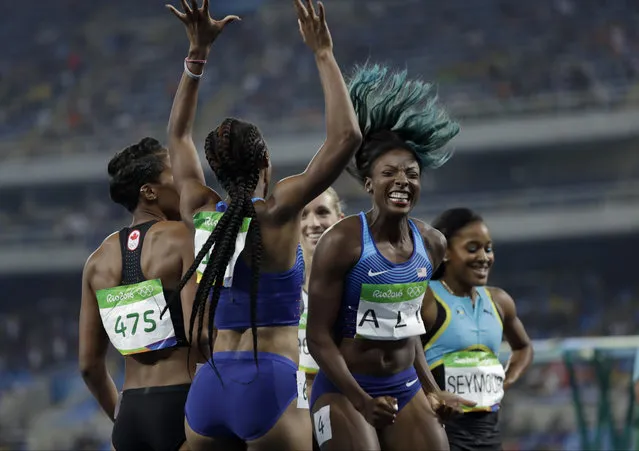 Brianna Rollins from the United States, center left, celebrates winning the gold medal in the women's 100-meter hurdles final with second placed United States' Nia Ali, center right, during the athletics competitions of the 2016 Summer Olympics at the Olympic stadium in Rio de Janeiro, Brazil, Wednesday, August 17, 2016. (Photo by David J. Phillip/AP Photo)