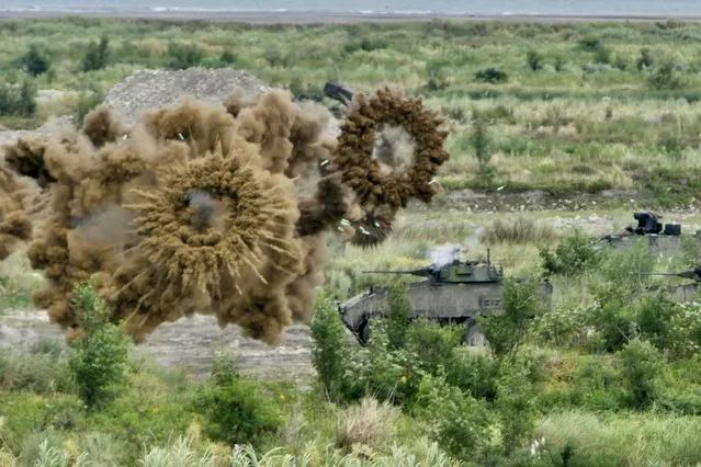 Two domestically-made armoured vehicles launch smoke grenades during the annual Han Kuang military drills in Taichung on July 16, 2020. The five-day “Han Kuang” (Han Glory) military drills starting on July 14 aimed to test how the armed forces would repel an invasion from China, which has vowed to bring Taiwan back into the fold – by force if necessary. (Photo by Sam Yeh/AFP Photo)