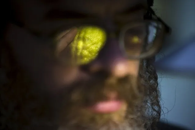 An ultra-Orthodox Jewish man inspects an etrog, citrus fruit used in rituals during the upcoming Jewish holiday of Sukkot in Jerusalem's Mea Shearim neighbourhood, September 27, 2015. The etrog used during the week-long Jewish holiday of Sukkot which begins at sundown on Sunday. (Photo by Amir Cohen/Reuters)