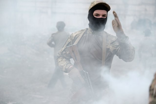 Young Ukrainian civilians with the 'Centuria' organisation take part in tactical training in Kyiv Oblast, Ukraine, 15 April 2025. Founded in 2020 by veterans of the Azov Brigade, Centuria provides a space for youth aged 14 and above who are interested in defending Ukraine to gain military and combat medical training, with a focus on national identity. The training sessions do not involve live ammunition. The organisation says it has over 3,000 members and branches in several Ukrainian cities. (Photo by Maria Senovilla/EPA)