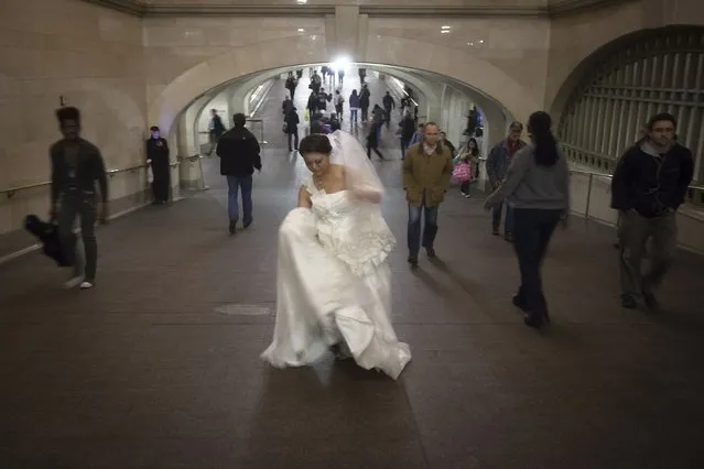 A bride walks though Grand Central Terminal in New York October 24, 2014. (Photo by Carlo Allegri/Reuters)
