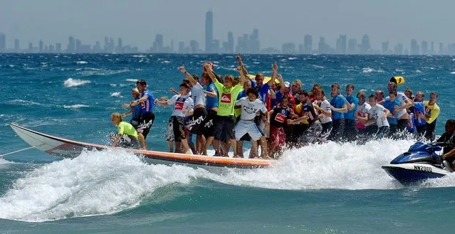 World Championship Tour and local surfers ride on the world's longest surfboard to set an unofficial Guinness World Record of 47 surfers on the 40-foot board shaped by Gold Coast shaper Nev Hyman, at Snapper Rock on the Gold Coast, of Australia, Saturday  March 5, 2005. The record attempt is part of the “Tsunamirun”, a charity set up to raise funds for Tsunami victims. (Photo by Steve Holland/Associated Press)