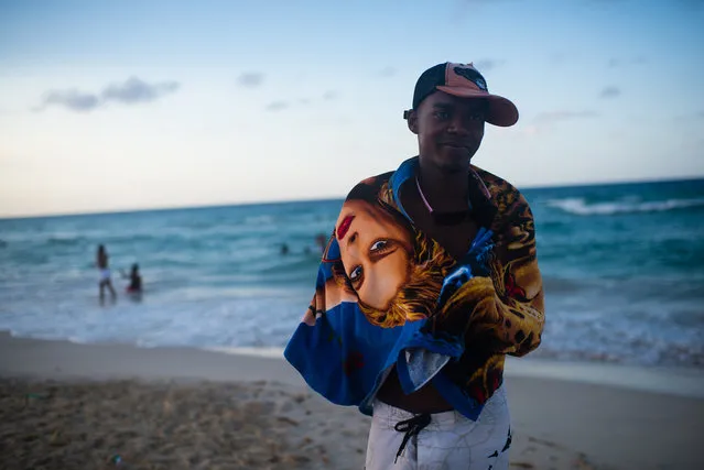 Mariano Gracial, 25, wraps himself in a towel at Santa Maria beach, about 15 miles from Havana. It is the closest beach to Havana. The government is demolishing buildings all over the coast of East Havana and recovering and restoring beach dunes. (Photo by Sarah L. Voisin/The Washington Post)