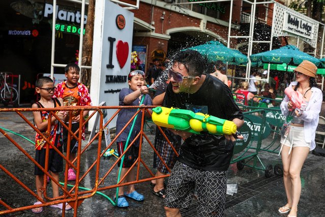 Revellers play with water as they celebrate the Songkran holiday, which marks the Thai New Year, in Bangkok, Thailand, on April 12, 2025. (Photo by Chalinee Thirasupa/Reuters)