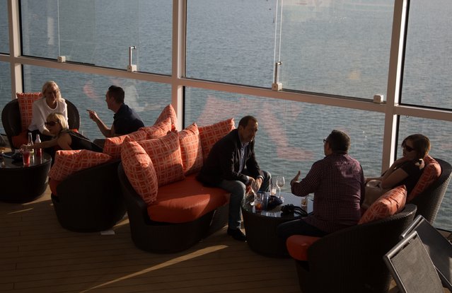 People sit and enjoy the facilites on the top deck onboard the cruise ship Quantum of the Seas which is currently docked at Southampton on October 31, 2014 in Southampton, England. (Photo by Matt Cardy/Getty Images)