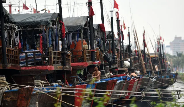 In this October 3, 2015 photo provided by China's Xinhua News Agency, ships berth at Xingang harbor in Haikou, capital of south China's Hainan Province. Tens of thousands of people have been evacuated from coastal areas of southern China, with a strong typhoon that was moving toward the mainland on Sunday, Oct. 4,  already bringing powerful winds and heavy rain to the region. (Photo by Zhao Yingquan/Xinhua News Agency via AP Photo)