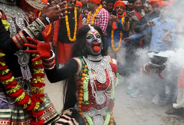A person dressed as Hindu goddess Kali performs a dance during a religious procession during the Maha Shivratri festival in Allahabad, India, February 13, 2018. (Photo by Jitendra Prakash/Reuters)