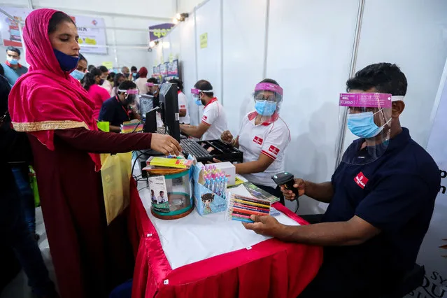 Booksellers wearing protective face shields sell books and other items during the “Colombo International Book Fair” in Colombo, Sri Lanka, 18 September 2020. The Colombo International Book Fair, organized by Sri Lanka Book Publishers' Association, is held every year for a week in September. This is the 22nd edition of the largest book fair in Sri Lanka. (Photo by Chamila Karunarathne/EPA/EFE/Rex Features/Shutterstock)