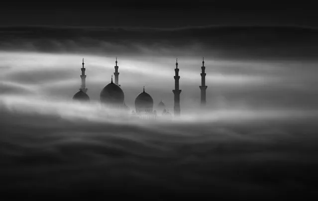 Photographer Khalid Alhammadi really has got his head in the clouds as he scales some of the Middle East’s tallest buildings to photograph iconic landmarks high above the rising mist. Khalid’s breathtaking shots over Abu Dhabi look almost otherworldly, with skyscraper tips and mosque towers poking through the eerie fog. While Dubai’s buildings receive a large amount of exposure when they are photographed within the mist, Abu Dhabi’s wonders are not as well photographed, Khalid, 26, said. Here: The Sheikh Zayed Grand Mosque. (Photo by Khalid Alhammadi/Caters News Agency)