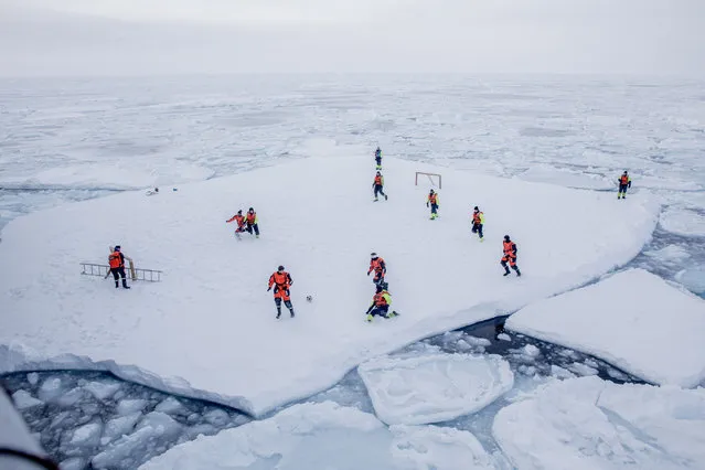 KV Svalbard's crew, formed by Norwegian Navy privates and scientists from Norwegian Institute of Marine Research, play soccer as they are protected from polar bears by armed guards in the arctic environment in the sea around Greenland, March 22, 2018. (Photo by Marius Vagenes Villanger/Reuters/Kystvakten/Sjoforsvaret/NTB Scanpix)
