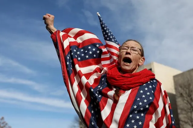 A supporter of U.S. President Donald Trump wearing the color of the U.S. flag raises her fist as she participates in a “Stop the Steal” protest after the 2020 U.S. presidential election was called for Democratic candidate Joe Biden, in Lansing, Michigan, U.S. November 14, 2020. (Photo by Emily Elconin/Reuters)