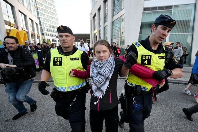 Swedish climate activist Greta Thunberg (C) wearing the keffiyeh scarf is removed by police during a pro-Palestinian demonstration outside the Malmo Arena venue ahead of the final of the 68th Eurovision Song Contest (ESC) 2024 on May 11, 2024 in Malmo, Sweden. (Photo by Johan Nilsson/TT News Agency via AFP Photo)