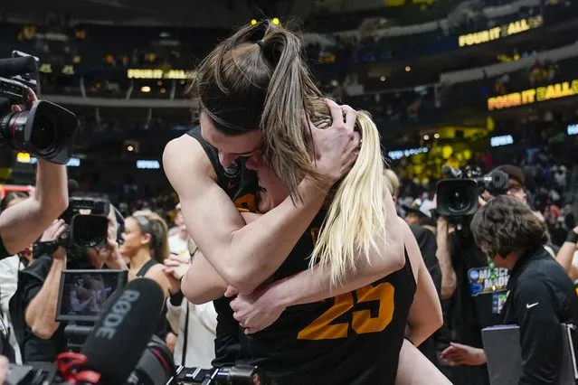 Iowa's Caitlin Clark and Monika Czinano celebrate after an NCAA Women's Final Four semifinals basketball game against South CarolinaFriday, March 31, 2023, in Dallas. Iowa won 77-73 to advance to the championship on Sunday. (Photo by Tony Gutierrez/AP Photo)