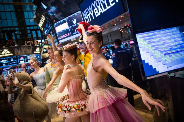 New York City Ballet dancers from this year's production of The Nutcracker visit the floor of the New York Stock Exchange on the morning of December 24, 2014 in New York City. The market opened above 18,000 points for the first time in its history this morning. (Photo by Andrew Burton/Getty Images)