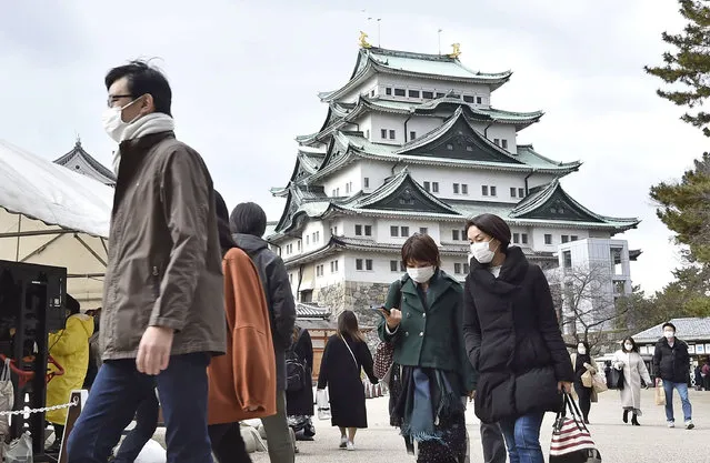 People wearing face masks visit Nagoya castle in Nagoya, central Japan, Sunday, December 13, 2020. Japan’s daily coronavirus cases have exceeded 3,000 for the first time while the government delays stricter measures for fear of hurting the economy ahead of the holiday season. (Photo by Kyodo News via AP Photo)