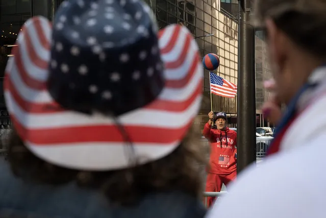 A Trump supporter performs outside of Trump Tower in New York, NY on Tuesday, April 4, 2023, as crowds await the departure of former president Donald Trump. Trump became the first sitting or former U.S. president to be indicted and plans to turn himself in Tuesday and then appear in court in New York to be arraigned in a case that involves payoffs through an intermediary to adult-film actress Stormy Daniels to conceal an alleged affair ahead of the 2016 election. (Photo by Joe Lamberti for The Washington Post)