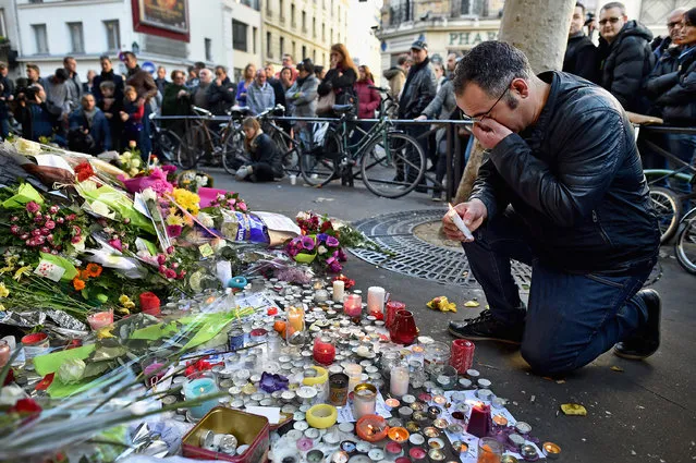 Members of the public gather to lay flowers and light candles at La Belle Equipe restaraunt on Rue de Charonne following Fridays terrorist attack on November 15, 2015 in Paris, France. As France observes three days of national mourning members of the public continue to pay tribute to the victims of Friday's deadly attacks. (Photo by Jeff J. Mitchell/Getty Images)