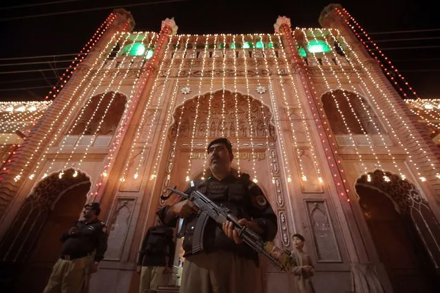 A general view of an illuminated Mosque as Pakistani security officials stands guard outside during Muslims offering special Taravih prayers, of the 27th night of Ramadan, the holy month of fasting, in Peshawar, Pakistan, 17 April 2023. Muslims around the world celebrate the holy month of Ramadan by praying during the night time and abstaining from eating, drinking, and sexual acts during the period between sunrise and sunset. Ramadan is the ninth month in the Islamic calendar and it is believed that the revelation of the first verse in Koran was during its last 10 nights. Laylat al-Qadr (Arabic for Night of Destiny) is believed to be the night when the first verse of Islam's holy book, the Koran, was revealed to Prophet Muhammed, the exact date is not known but it is believed to be on the odd nights of the last 10 nights of the holy month of Ramadan. (Photo by Bilawal Arbab/EPA)