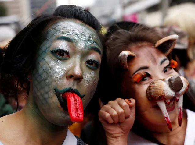 Participants in costumes pose for the camera during a Halloween parade in Kawasaki, south of Tokyo, Japan October 30, 2016. (Photo by Kim Kyung-Hoon/Reuters)