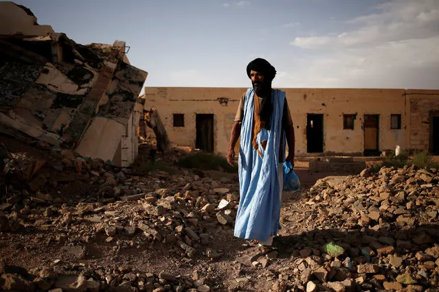 Saleh Sidi Ahmed, 56, a soldier with the Western Sahara Polisario forces, walks near the ruins of a house bombed by the disputed region war with Morocco more than 25 years ago in Tifariti, Western Sahara, September 8, 2016. (Photo by Zohra Bensemra/Reuters)