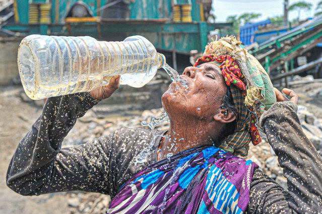 A Thirsty Stone worker of Dhupagul Area in Sylhet, Bangladesh on May 11, 2023 is taking a sip of water amid the current severe heatwave nationwide. (Photo by Md Rafayat Haque Khan/ZUMA Press Wire/Rex Features/Shutterstock)