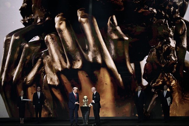 US President Trump shakes hands with FIFA President Gianni Infantino prior receiving the FIFA Peace Prize during the draw for the 2026 FIFA Football World Cup taking place in the US, Canada and Mexico, at the Kennedy Center, in Washington, DC, on December 5, 2025. (Photo by Brendan Smialowski/AFP via Getty Images)