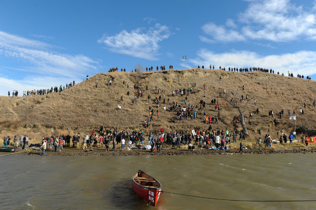 Protesters occupy an island near their encampment while police stand guard during a protest of the Dakota Access pipeline near the Standing Rock Indian Reservation near Cannon Ball, North Dakota November 6, 2016. (Photo by Stephanie Keith/Reuters)