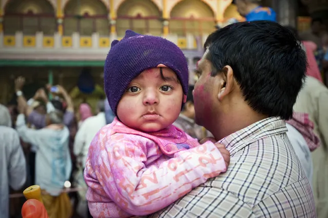 “The Toddler”. When I was taking photos of the people celebrating Holi Festival, I noticed this toddler was looking at me for a while. Location: Mathura, India. (Photo and caption by Ng Hock How/National Geographic Traveler Photo Contest)