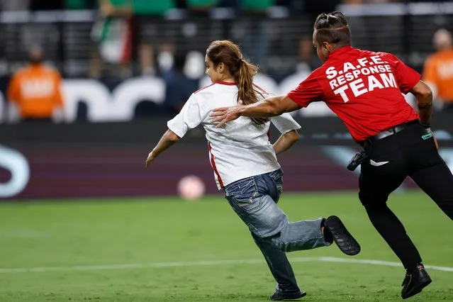 A fan runs onto the pitch as security follows during the second half of the CONCACAF Gold Cup semifinal soccer match between Mexico and Jamaica in Las Vegas, Nevada, USA on July 12, 2023. (Photo by Caroline Brehman/EPA/EFE)