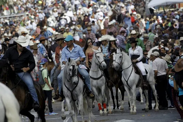 People ride horses as they take part in a traditional horse parade through the streets of San Jose, Costa Rica December 26, 2015. (Photo by Juan Carlos Ulate/Reuters)