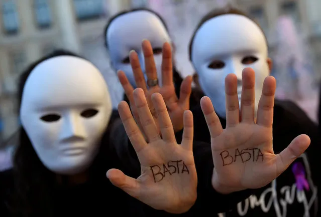 Gender studies students wearing masks pose with the word “Enough” written on their hands during a performance to commemorate victims of gender violence, during the U.N. International Day for the Elimination of Violence against Women, in Oviedo, Spain November 25, 2016. (Photo by Eloy Alonso/Reuters)