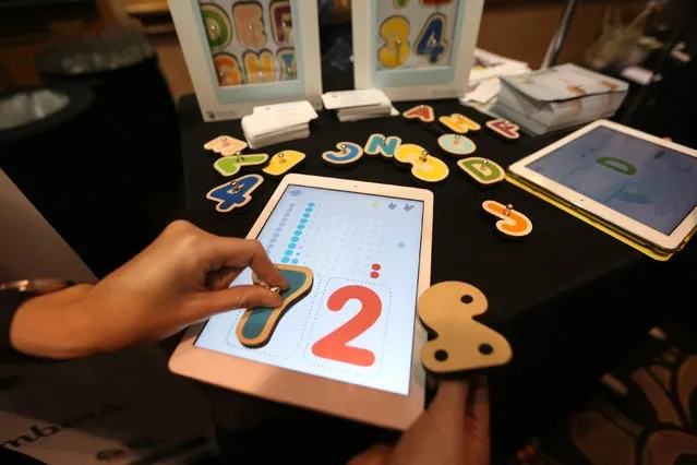 Smart Letters interactive wooden letters are used with a Marbotic app on a tablet for learning skills at The CES Unveiled press event, January 4, 2016 in Las Vegas, Nevada ahead of the CES 2016 Consumer Electronics Show. (Photo by David McNew/AFP Photo)