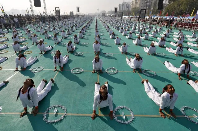 School children attend a yoga session on the last day of the 10-day long camp in Ahmedabad, India, January 10, 2016. (Photo by Amit Dave/Reuters)