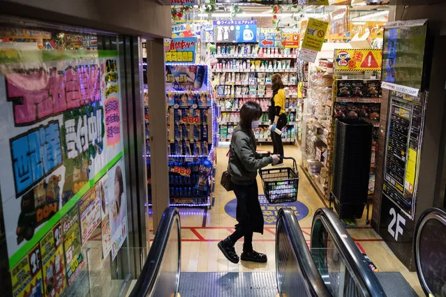 A woman shops at a supermarket in Shinjuku district of Tokyo on April 6, 2021. (Photo by Yuki Iwamura/AFP Photo)