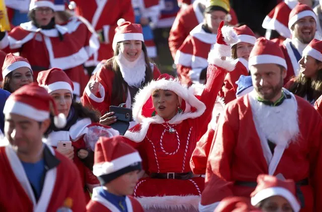 Participants in a charity Santa Run, warm up before the start of the event in Victoria Park, London, Britain December 4, 2016. (Photo by Phil Noble/Reuters)