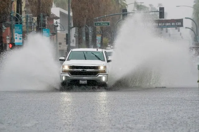 A truck moves through standing water as Tropical Storm Hilary approaches Palm Springs, California, U.S., August 20, 2023. (Photo by Bryan Woolston/Reuters)