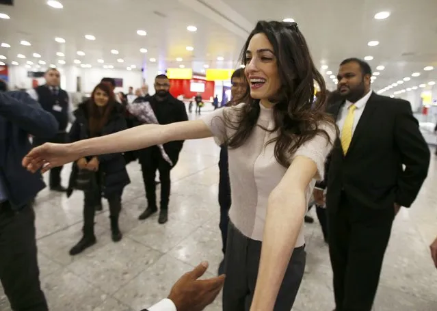 Lawyer Amal Clooney prepares to embrace the deposed President of the Maldives Mohamed Nasheed as he arrives at Heathrow airport in London, January 21, 2016. Nasheed, who is represented by Amal Clooney, is in London for medical treatment according to local media. (Photo by Peter Nicholls/Reuters)
