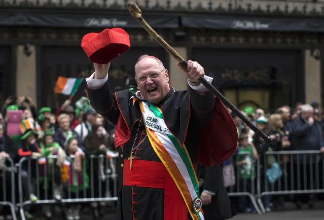 Cardinal Timothy Dolan, Archbishop of the Archdiocese of New York, waves to spectators as he marches as the Grand Marshall of the 254th New York City St. Patrick's Day parade up 5th Avenue in the Manhattan Borough of New York, March 17, 2015. (Photo by Mike Segar/Reuters)