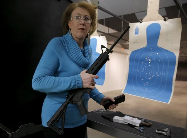Janet Huckabee, wife of U.S. Republican presidential candidate Mike Huckabee holds an AR-15 assault rifle at a gun shop during a campaign event in Hiawatha, Iowa, United States, January 25, 2016. (Photo by Jim Young/Reuters)