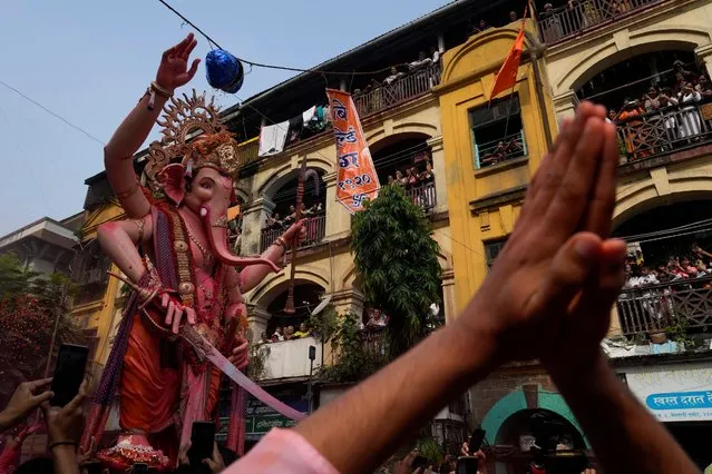 An idol of elephant-headed Hindu god Ganesha is taken for immersion on the final day of the ten-day long Ganesh Chaturthi festival in Mumbai, India, Thursday, September 28, 2023. The festival is a celebration of the birth of Ganesha, the Hindu god of wisdom, prosperity and good fortune. (Photo by Rafiq Maqbool/AP Photo)